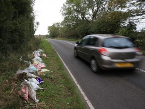 In this file photo taken Oct. 10, 2019, floral tributes lay on the roadside near RAF Croughton in Northamptonshire, central England, at the spot where British motorcyclist Harry Dunn was killed as he travelled along the B4031 on Aug. 27.