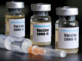 Small bottles labeled with a "Vaccine COVID-19" sticker and a medical syringe are seen in this illustration taken taken April 10, 2020.