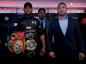 Anthony Joshua and Kubrat Pulev pose with promoter Eddie Hearn during the press conference.