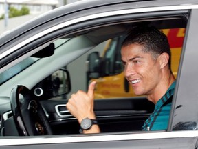 Juventus' Cristiano Ronaldo gestures as he leaves Juventus Training Center following the outbreak of the coronavirus disease (COVID-19), Turin, Italy, May 19, 2020.