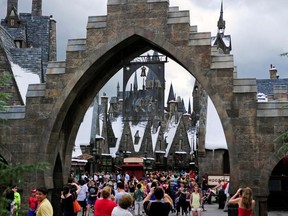 Guests walk in and out of Hogsmeade Village during a media preview for The Wizarding World of Harry Potter-Diagon Alley at the Universal Orlando Resort in Orlando, Florida June 19, 2014.