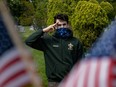 A member of Boy Scouts of America wearing a protective mask salutes at a ceremony for Veterans who are unable to give military honors during Memorial Day following the outbreak of the coronavirus disease (COVID-19) in the Staten Island borough of New York U.S., May 25, 2020.