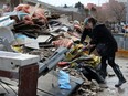 Items are thrown out because of water damage from the flood at a home in downton Fort McMurray, Alta. on Saturday, May 2, 2020. Laura Beamish/Fort McMurray Today/Postmedia Network