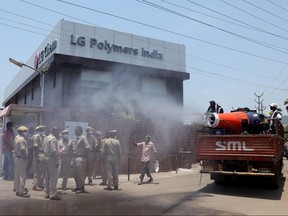 Municipal workers decontaminate outside of the LG Polymers Plant following a gas leak at the plant in Visakhapatnam, India, May 8, 2020.