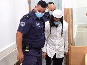 Amiram Ben-Uliel is brought for a verdict in the case of the 2015 arson attack at the Central Lod District Court in Lod, Israel May 18, 2020.