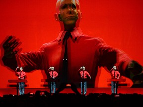 In this file photo taken on Jan. 6, 2015, the piece "Roboter" of the German band Kraftwerk is performed during a concert at the Neue Nationalgalerie (New National Gallery) museum in Berlin.