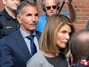 In this file photo taken on Aug. 27, 2019, actress Lori Loughlin and husband Mossimo Giannulli exit Boston Federal Court after a pre-trial hearing in Boston.