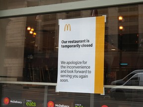 A sign hangs in the window of a McDonald's restaurant announcing it is temporarily closed  on April 30, 2020, in Chicago.