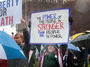 Demonstrators hold a rally in front of the Michigan state capital building to protest the governor's stay-at-home order on Thursday, May 14, 2020 in Lansing, Michigan.