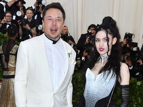 Elon Musk and Grimes arrive for the 2018 Met Gala on May 7, 2018, at the Metropolitan Museum of Art in New York. - The Gala raises money for the Metropolitan Museum of Arts Costume Institute. The Gala's 2018 theme is Heavenly Bodies: Fashion and the Catholic Imagination.