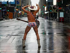 The Naked Cowboy poses in a desolate Times Square on April 13, 2020 in New York.