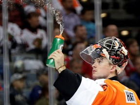 Philadelphia Flyers goalie Carter Hart takes a break during a game against the Chicago Blackhawks in Prague.