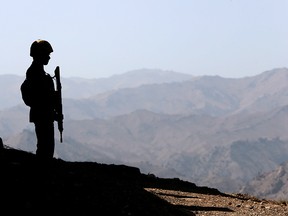 A soldier stands guard along the border fence outside the Kitton outpost on the border with Afghanistan in North Waziristan, Pakistan, Oct. 18, 2017.