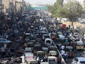Commuters are seen in a traffic jam on a street after the government eased a nationwide lockdown imposed as a preventive measure against the COVID-19 coronavirus, in Karachi on May 18, 2020.