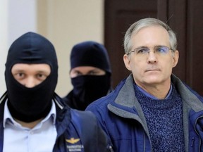 Former U.S. Marine Paul Whelan, accused of espionage, is escorted inside a court building in Moscow, Oct. 24, 2019.