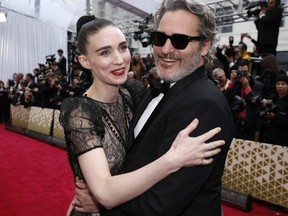 Joaquin Phoenix and Rooney Mara embrace on the red carpet during the 92nd Academy Awards in Hollywood February 9, 2020.