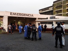 Healthcare workers and members of the Bolivarian national police wait for the arrival of prisoners outside a hospital after a riot erupted inside a prison in Guanare, Venezuela May 1, 2020.