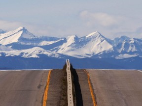 Alberta Provincial Highway 23 stretches toward High River, south of Calgary with the Rocky Mountains in the background on May 3, 2017.