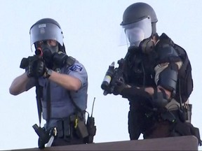 Police aim at a Reuters TV cameraman during nationwide unrest following the death of of George Floyd in Minneapolis police custody, in Minneapolis, May 30, 2020.