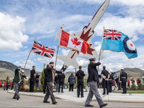 Flags are carried at a tribute ceremony to honour Capt. Jennifer Casey at the Kamloops Airport Thursday May 21, 2020.