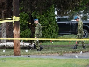 Members of the Canadian Forces walk by the crash site of a Canadian Forces Snowbirds jet in Kamloops, B.C., Monday, May 18, 2020.