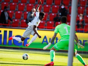 Bayern Munich's Alphonso Davies shoots on goal against FC Union Berlin as the German Bundesliga resumes behind closed doors following the outbreak of COVID-19.