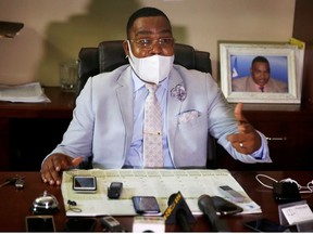 Maxime Augustin, a government commissioner wearing a protective face mask, during a press conference at the Crois-Des-Bouquets prosecutor's office after the hearing of Yves Jean-Bart, president of the Haitian Football Federation, who has been accused of sexually abusing young footballers at the country's national training centre, Crois-Des-Bouquets, Haiti, May 14, 2020.