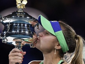 Sofia Kenin kisses the Daphne Akhurst Memorial Cup after winning against Garbine Muguruza in their women's singles final match at the Australian Open in Melbourne on Feb. 1, 2020.