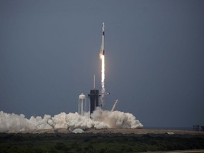 The SpaceX Falcon 9 rocket launches into space with NASA astronauts Bob Behnken and Doug Hurley aboard the rocket from the Kennedy Space Center in Cape Canaveral, Fla., on Saturday, May 30, 2020.