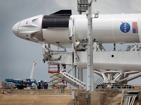 Workers prepare the SpaceX Falcon 9 rocket with the Crew Dragon spacecraft attached for tomorrow's scheduled liftoff from launch pad 39A at the Kennedy Space Center on May 25, 2020, in Cape Canaveral, Fla.