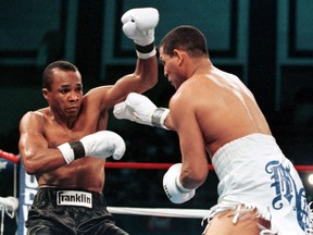 Sugar Ray Leonard (left) loses his balance after a blow from defending champion Hector "Macho" Camacho in Atlantic City.