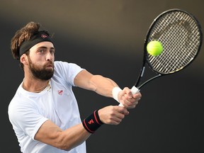 In this file photograph taken on Jan, 23, 2020, Georgia's Nikoloz Basilashvili hits a return against Spain's Fernando Verdasco during their men's singles match on day four of the Australian Open tennis tournament in Melbourne.