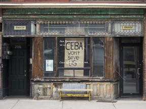 A storefront with the message "CEBA won't save us", referencing the Canada Emergency Business Account, in Toronto, April 23, 2020.