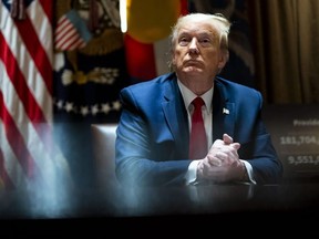 President Donald Trump looks on he as meets with Colorado Governor Jared Polis and North Dakota Governor Doug Burgum in the Cabinet Room of the White House on May 13, 2020 in Washington.