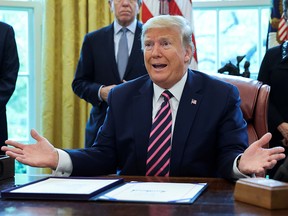 U.S. President Donald Trump speaks during a signing ceremony for the "Paycheck Protection Program and Health Care Enhancement Act" in the Oval Office at the White House in Washington, D.C., April 24, 2020.