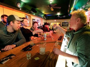 Owner Michael Mattson toasts the re-opening of the Friends and Neighbors bar following the Wisconsin Supreme Court's decision to strike down Governor Tony Evers' safer-at-home order against COVID-19 in Appleton, Wis., Wednesday, May 13, 2020.