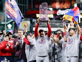 Manager Dave Martinez of the Washington Nationals hoists the Commissioners Trophy after defeating the Houston Astros 6-2 in Game 7 to win the 2019 World Series  at Minute Maid Park on Oct. 30, 2019 in Houston, Texas.