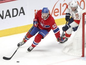 Montreal Canadiens' Jonathan Drouin holds off Florida Panthers Aleksander Barkov during second period in Montreal on Jan. 15, 2019.