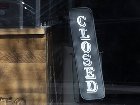 This file photo shows a closed sign posted at a business in Toronto that's temporarily closed due to the coronavirus pandemic.