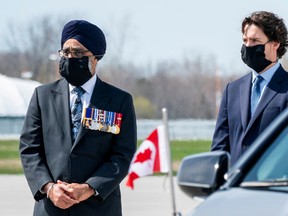 Canada's Minister of National Defence Harjit Sajjan (left) and Canada's Prime Minister Justin Trudeau, wearing protective face masks, attend a repatriation ceremony last month for the six Canadian Forces personnel killed in a helicopter crash in the Mediterranean.
Flight investigators have determined the helicopter did not respond as the crew on board expected before going down into the Mediterranean Sea.