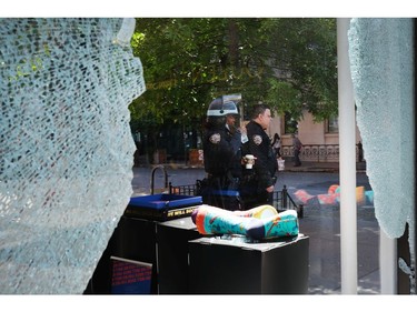 NEW YORK, NEW YORK - JUNE 01: Following a night of protests, police stand amongst broken windows and looted stores in Manhattans SoHo neighborhood on June 01, 2020 in New York City. Thousands of protesters took to the streets throughout the city to continue to show anger at Minneapolis Police officer Derek Chauvin who was filmed kneeling on George Floyd's neck before he was later pronounced dead at a local hospital. Floyd's death, the most recent in a series of deaths of black Americans while in police custody, has set off days and nights of protests across the country.