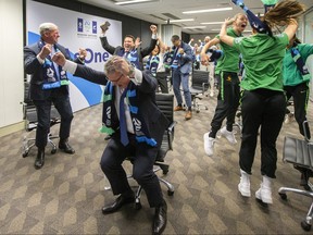 Chris Nikou, Chairman of Football Federation Australia, centre, along with officials and players react as FIFA announced Australia as the hosts to the 2023 FIFA Women's World Cup at the FFA Offices on June 26, 2020 in Sydney, Australia.