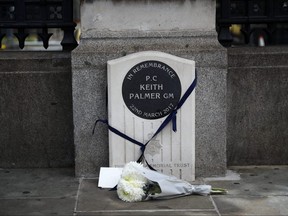 A bouquet of flowers is laid down at the memorial stone for PC Keith Palmer in London, June 14, 2020.
