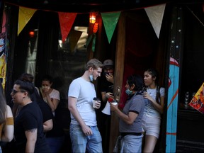 People drink outside a bar during the reopening phase following the COVID-19 outbreak in the East Village neighbourhood of New York City, June 13, 2020.