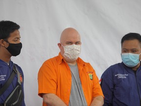 Russ Albert Medlin, a U.S. national and FBI fugitive, is seen under arrest on charges of sexually abusing minors, according to a spokesman from the Jakarta police, in Jakarta, Indonesia June 16, 2020.