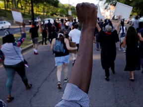 Marchers take part in a Juneteenth Awareness Walk to demonstrate against racial inequality in the aftermath of the death in Minneapolis police custody of George Floyd, in Boston, Massachusetts, June 18, 2020.