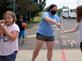 Children routinely sanitize to prevent the spread of coronavirus disease (COVID-19) at Farmington Family YMCA summer camp in Farmington Hills, Michigan, June 23, 2020.