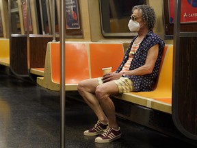 A man rides a subway in the Manhattan borough of New York City, June 25, 2020.