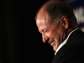 Ex-Edmonton Oilers defenceman Kevin Lowe listen to former teammate Wayne Gretzky speak during a news conference at the Westin Hotel on August 19 , 2014. Lowe is part of the Hockey Hall of Fame class of 2020.