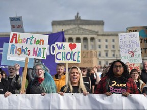 Abortion-rights demonstrators march through the streets of Belfast ahead of a meeting of the Stormont Assembly on abortion rights and gay marriage on October 21, 2019 in Belfast.